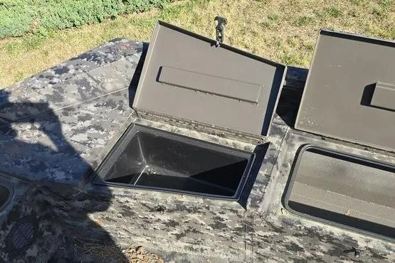 Slide: The Image of Open storage compartments on a 2026 Havoc 1860 DBST boat, featuring a camouflage pattern. - 8