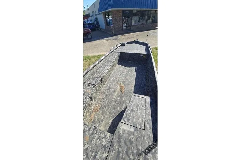 Slide: The Image of 2026 Havoc 1860 DBST boat with camouflage interior, parked outside a building. - 9