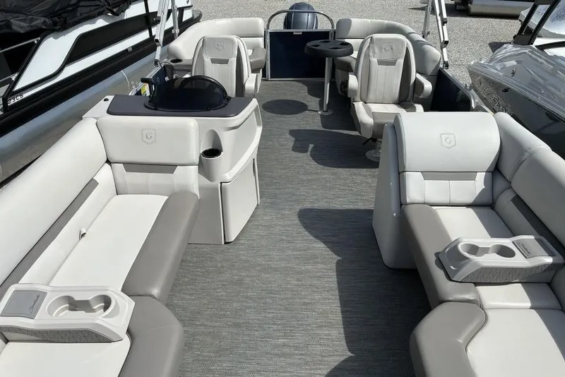 Slide: The Image of 2022 Godfrey Xperience 2286 SBX pontoon boat interior with plush seating and cup holders. - 2
