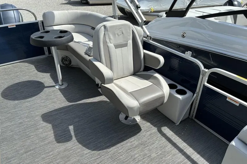 Slide: The Image of 2022 Godfrey Xperience 2286 SBX boat interior with seating and cup holders. - 6
