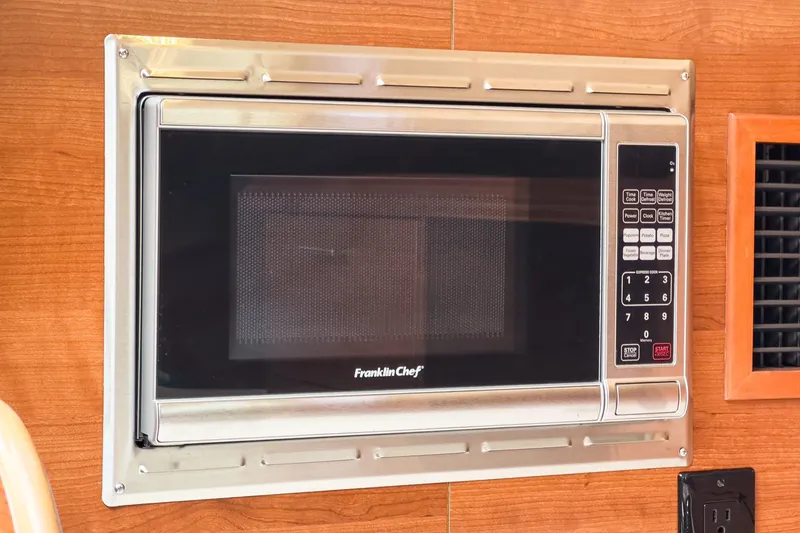 Slide: The Image of Built-in Franklin Chef microwave in a 2015 Hunter 33 RV kitchen. - 19