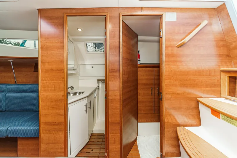 Slide: The Image of Interior of 2015 Hunter 33 sailboat featuring wooden cabinetry and compact bathroom. - 24