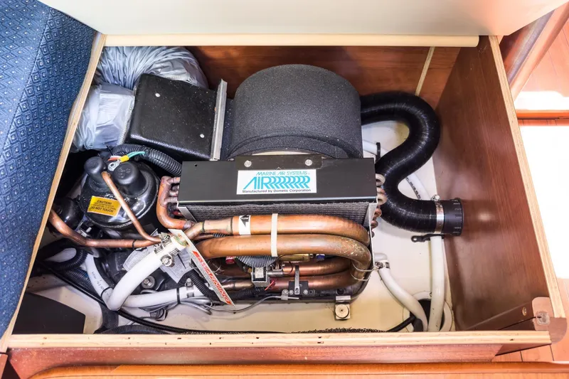 Slide: The Image of Engine compartment of a 2015 Hunter 33 sailboat, featuring marine air systems. - 27