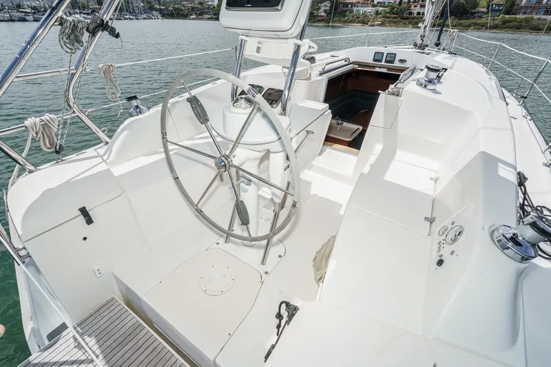 Slide: The Image of 2015 Hunter 33 sailboat cockpit with steering wheel, docked in marina. - 4