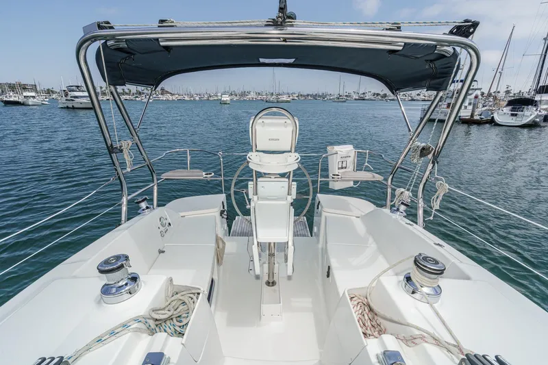 Slide: The Image of Cockpit view of 2015 Hunter 33 sailboat in marina, featuring steering and winches. - 5