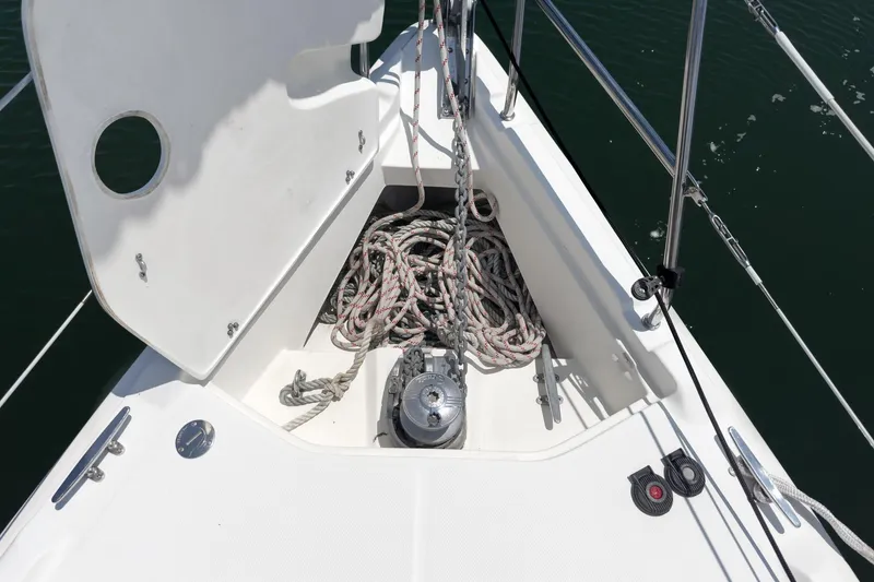 Slide: The Image of Anchor locker of a 2015 Hunter 33 sailboat with coiled ropes and winch. - 8
