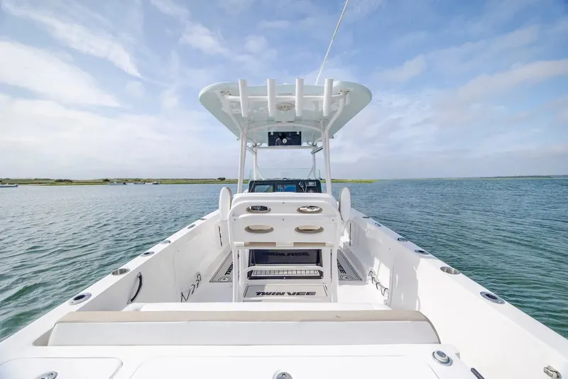 Slide: The Image of 2023 Twin Vee 240 GFX boat on calm water. - 11