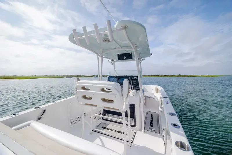 Slide: The Image of 2023 Twin Vee 240 GFX boat on calm water. - 12