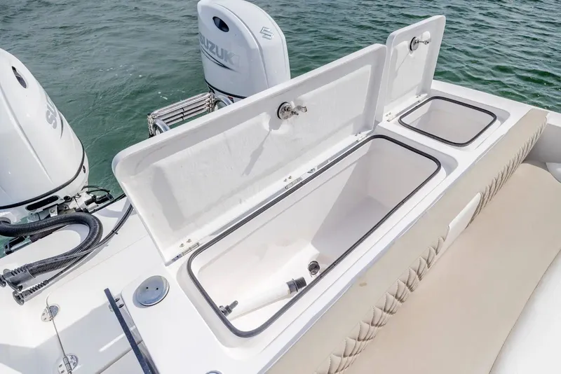 Slide: The Image of 2023 Twin Vee 240 GFX boat with open storage and engines. - 16