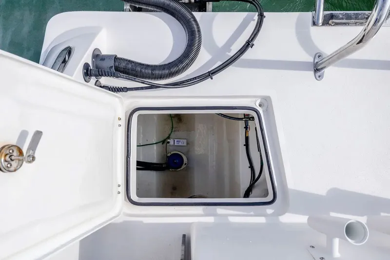 Slide: The Image of 2023 Twin Vee 240 GFX boat hatch with cables and connections. - 18