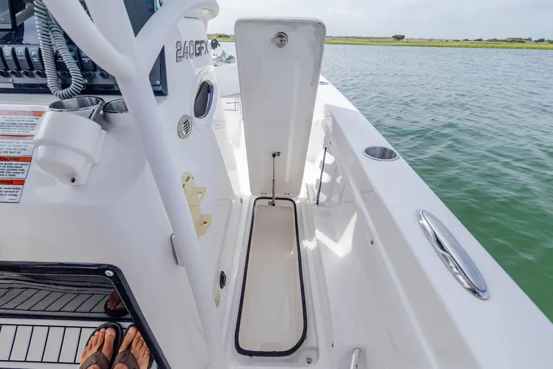 Slide: The Image of Interior view of 2023 Twin Vee 240 GFX boat by the water. - 19