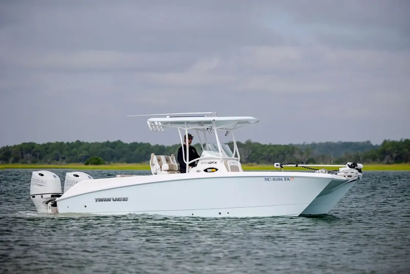 Slide: The Image of 2023 Twin Vee 240 GFX boat on calm water. - 2