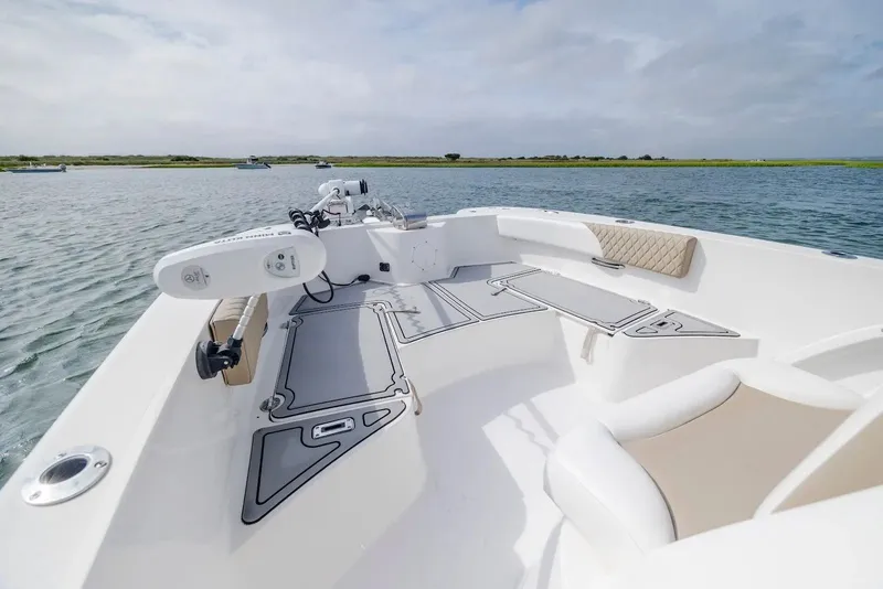 Slide: The Image of 2023 Twin Vee 240 GFX boat on calm water. - 21