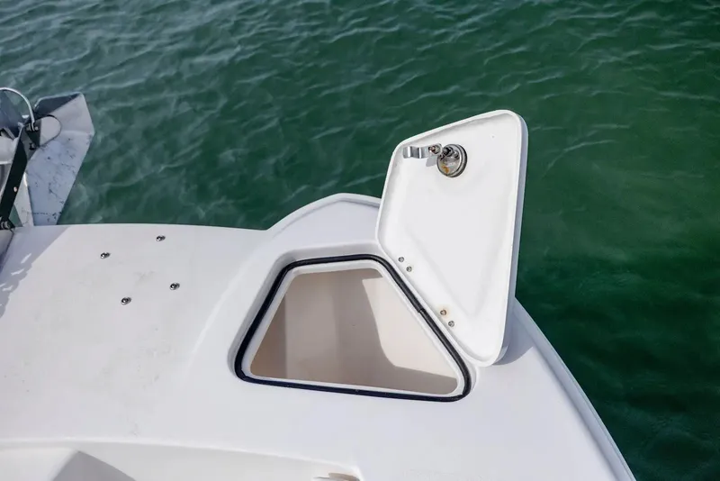 Slide: The Image of Open storage compartment on a 2023 Twin Vee 240 GFX boat. - 23