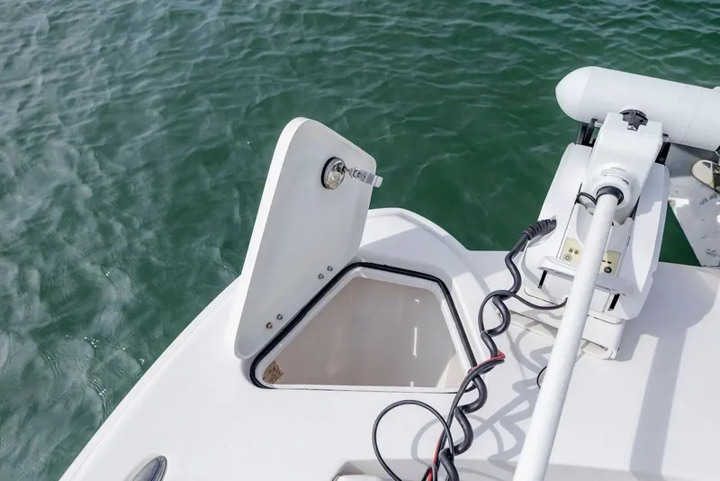 Slide: The Image of 2023 Twin Vee 240 GFX boat with open storage compartment and motor. - 24