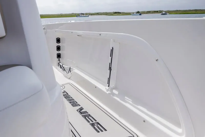 Slide: The Image of Interior view of 2023 Twin Vee 240 GFX boat by the water. - 26
