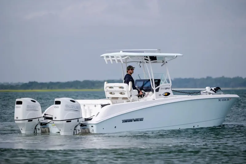 Slide: The Image of 2023 Twin Vee 240 GFX boat on calm water with Suzuki engines. - 5