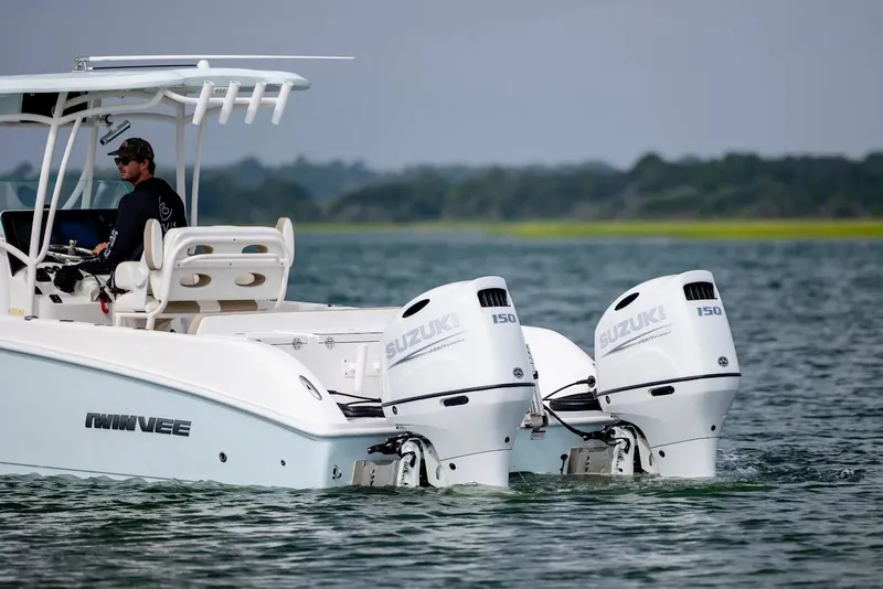 Slide: The Image of 2023 Twin Vee 240 GFX boat with Suzuki engines on water. - 6