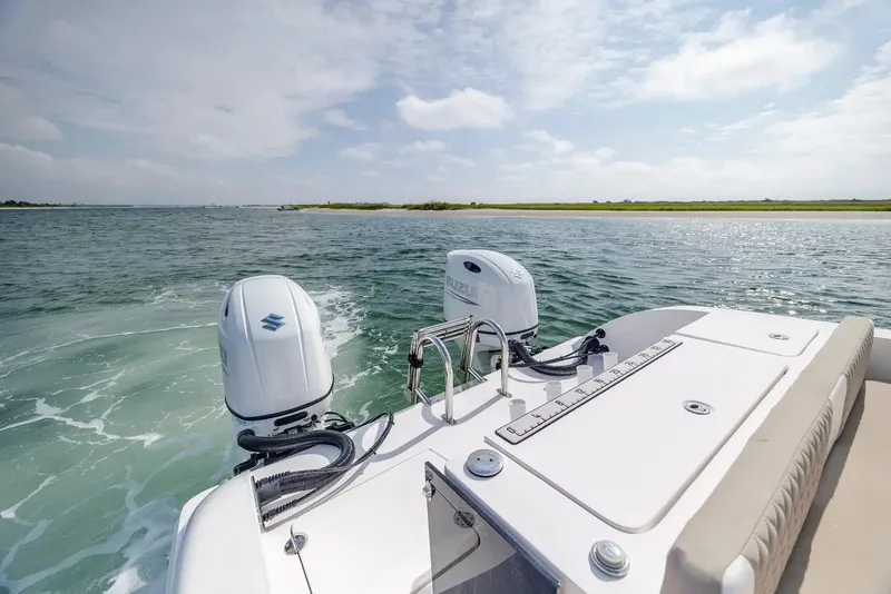 Slide: The Image of 2023 Twin Vee 240 GFX boat on open water with Suzuki engines. - 8