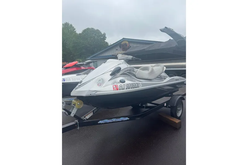 Slide: The Image of 2009 Yamaha VX Cruiser jet ski on trailer, parked outdoors on a cloudy day. - 10