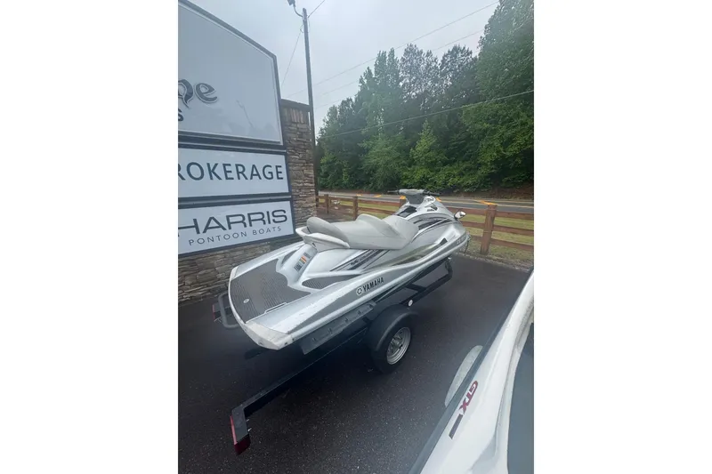Slide: The Image of 2009 Yamaha VX Cruiser jet ski on trailer, parked outdoors near brokerage sign. - 6