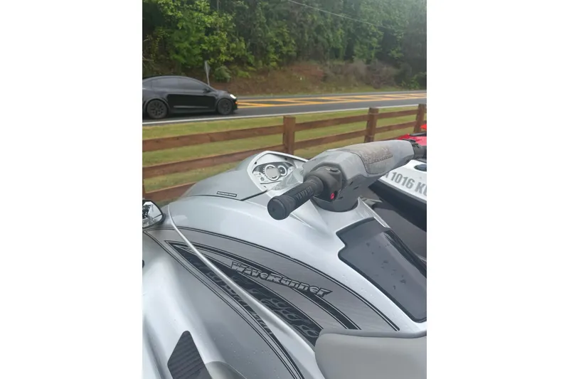 Slide: The Image of 2009 Yamaha VX Cruiser jet ski parked near a road with a car passing by. - 7