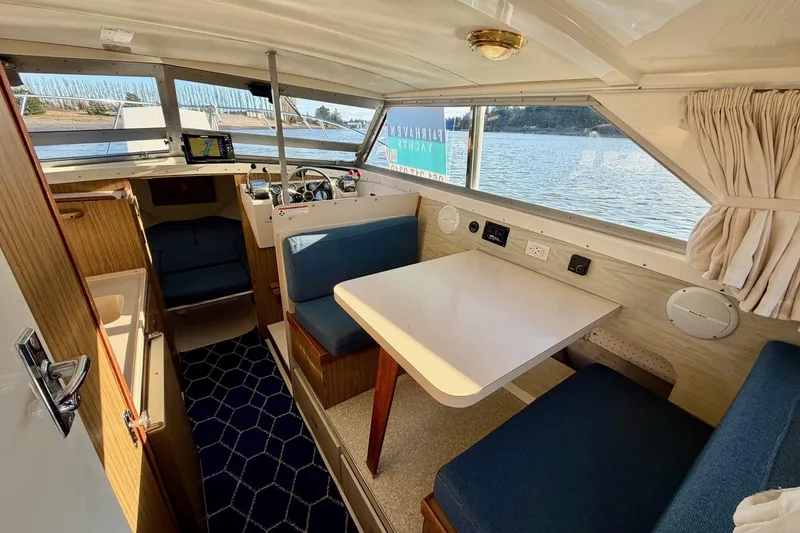 Slide: The Image of Interior of 1981 Bertram 28 Flybridge Cruiser with seating and navigation area. - 15