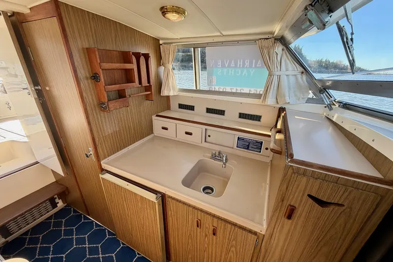 Slide: The Image of Interior of 1981 Bertram 28 Flybridge Cruiser with wood cabinetry and compact sink. - 17