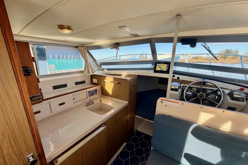 Slide: The Image of Interior of 1981 Bertram 28 Flybridge Cruiser with helm, seating, and kitchenette. - 21