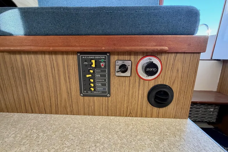 Slide: The Image of Control panel of a 1981 Bertram 28 Flybridge Cruiser with AC load center and switches. - 4
