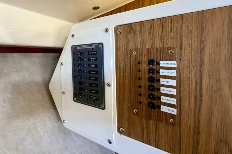 Slide: The Image of Electrical panel on 1981 Bertram 28 Flybridge Cruiser with labeled switches and controls. - 5