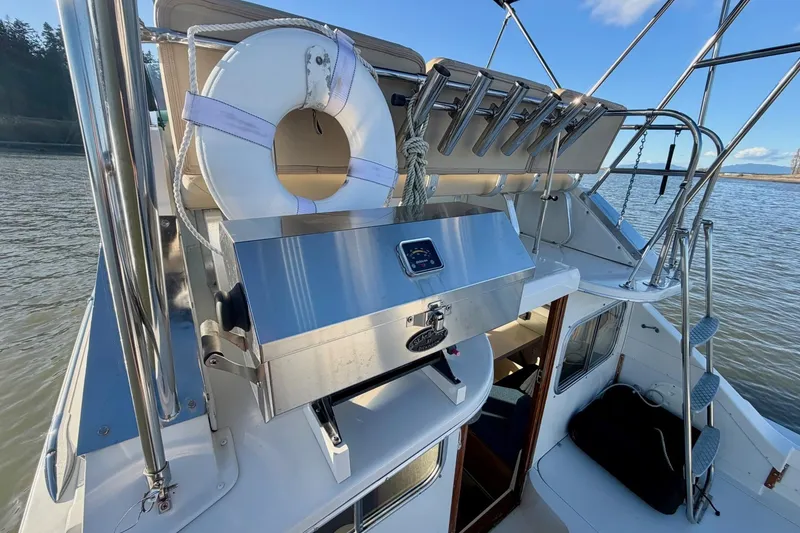 Slide: The Image of 1981 Bertram 28 Flybridge Cruiser with grill and life preserver on deck. - 8