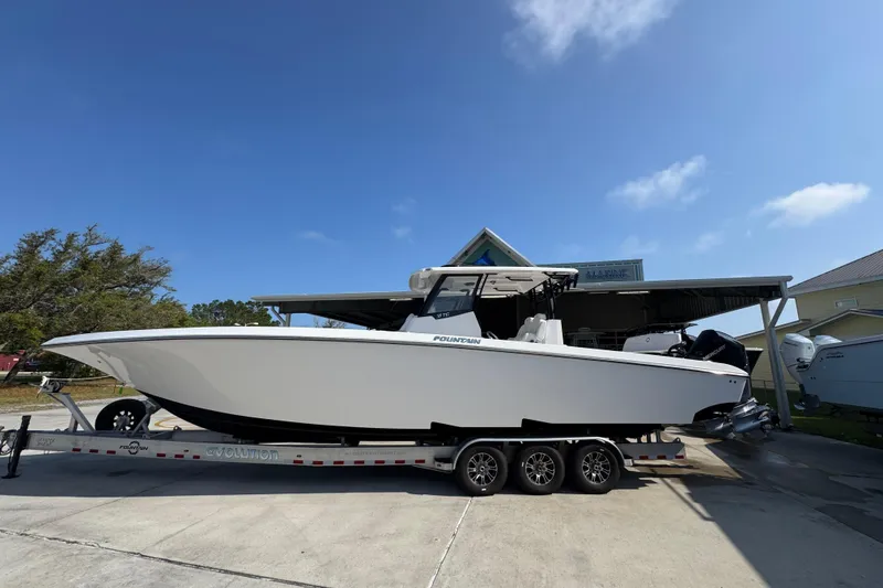 The Image of 2024 Fountain Bluewater 38 Tournament Edition boat on trailer, parked outdoors. - 1