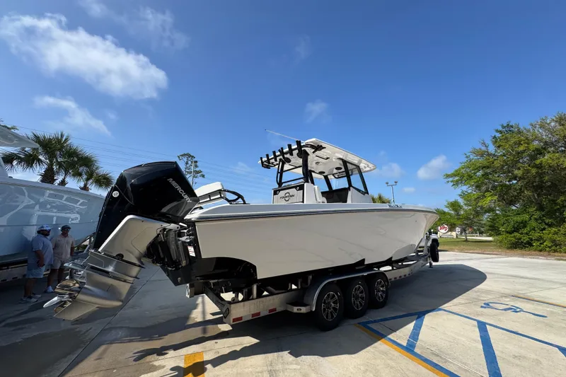 Slide: The Image of 2024 Fountain Bluewater 38 Tournament Edition boat on trailer under clear blue sky. - 10