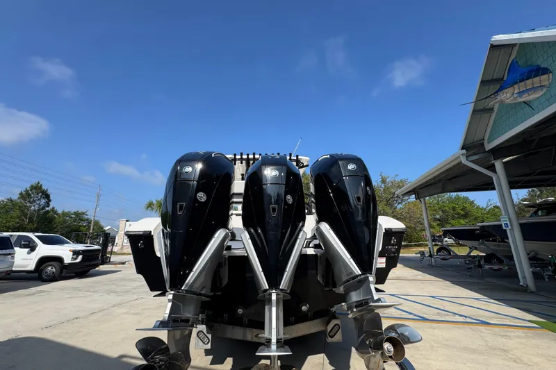 Slide: The Image of 2024 Fountain Bluewater 38 Tournament Edition with triple outboard engines in a marina setting. - 11