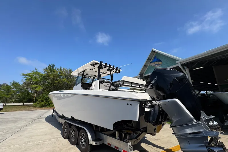 Slide: The Image of 2024 Fountain Bluewater 38 Tournament Edition boat on trailer, outdoors under clear sky. - 12