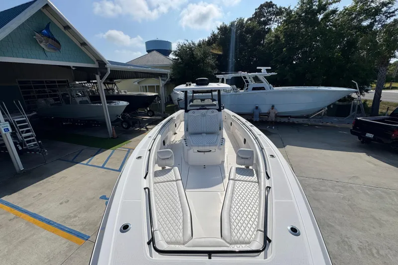 Slide: The Image of 2024 Fountain Bluewater 38 Tournament Edition boat displayed at a marina. - 18