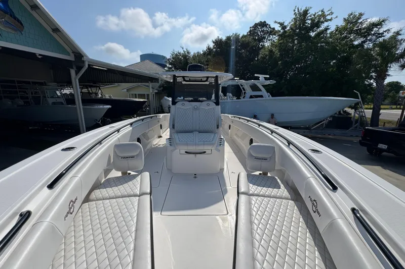 Slide: The Image of 2024 Fountain Bluewater 38 Tournament Edition boat with sleek white interior and seating. - 19