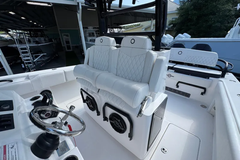 Slide: The Image of 2024 Fountain Bluewater 38 Tournament Edition boat interior with white seating and steering wheel. - 23