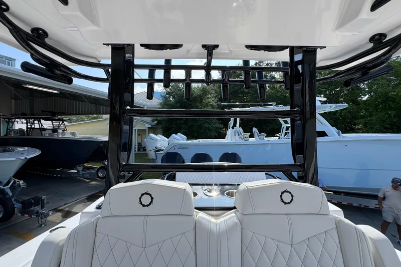 Slide: The Image of 2024 Fountain Bluewater 38 Tournament Edition boat interior with luxury seating and rod holders. - 25