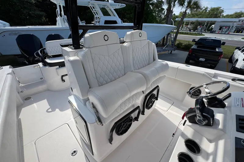Slide: The Image of 2024 Fountain Bluewater 38 Tournament Edition boat interior with white seating and steering console. - 26