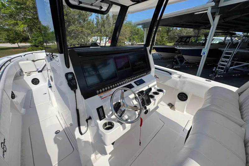 Slide: The Image of 2024 Fountain Bluewater 38 Tournament Edition boat cockpit with Garmin navigation system. - 27