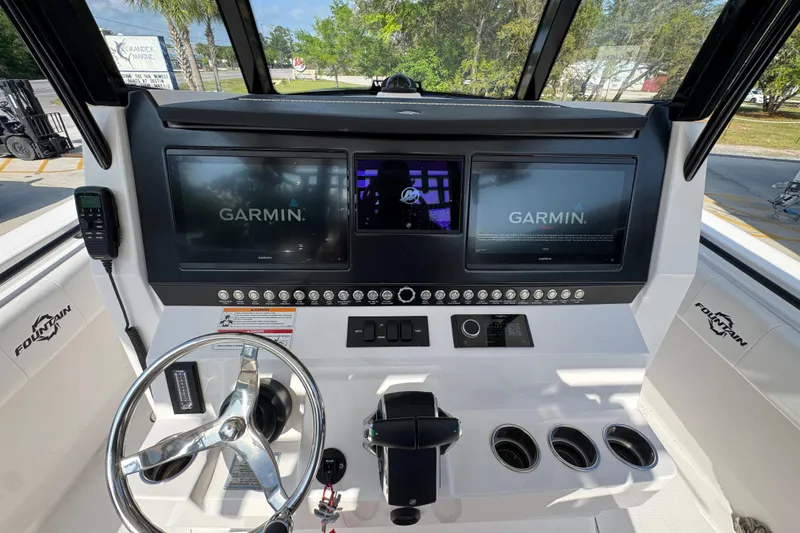 Slide: The Image of 2024 Fountain Bluewater 38 Tournament Edition helm with dual Garmin displays and steering wheel. - 28
