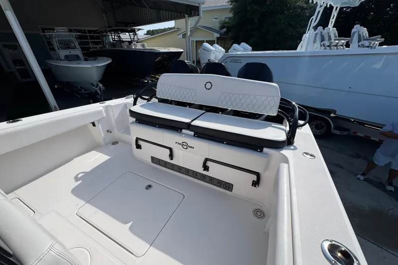 Slide: The Image of 2024 Fountain Bluewater 38 Tournament Edition boat interior with seating and storage. - 34