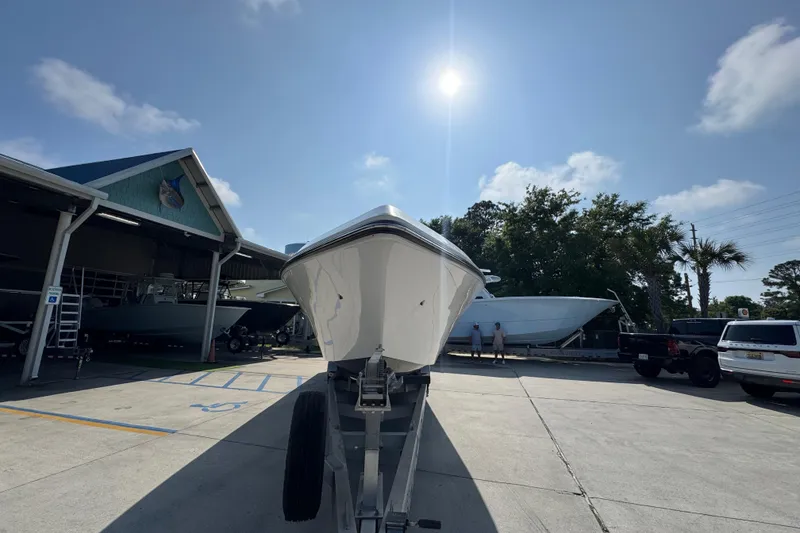 Slide: The Image of 2024 Fountain Bluewater 38 Tournament Edition boat on trailer under sunny sky. - 4