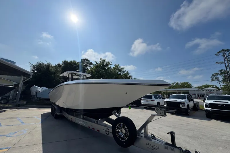 Slide: The Image of 2024 Fountain Bluewater 38 Tournament Edition boat on trailer under sunny sky. - 5