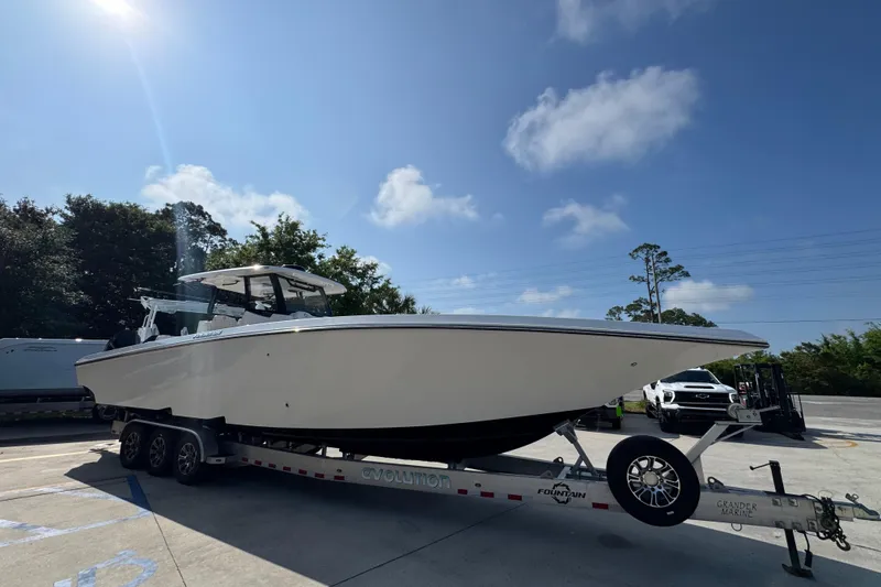 Slide: The Image of 2024 Fountain Bluewater 38 Tournament Edition boat on trailer under clear sky. - 6