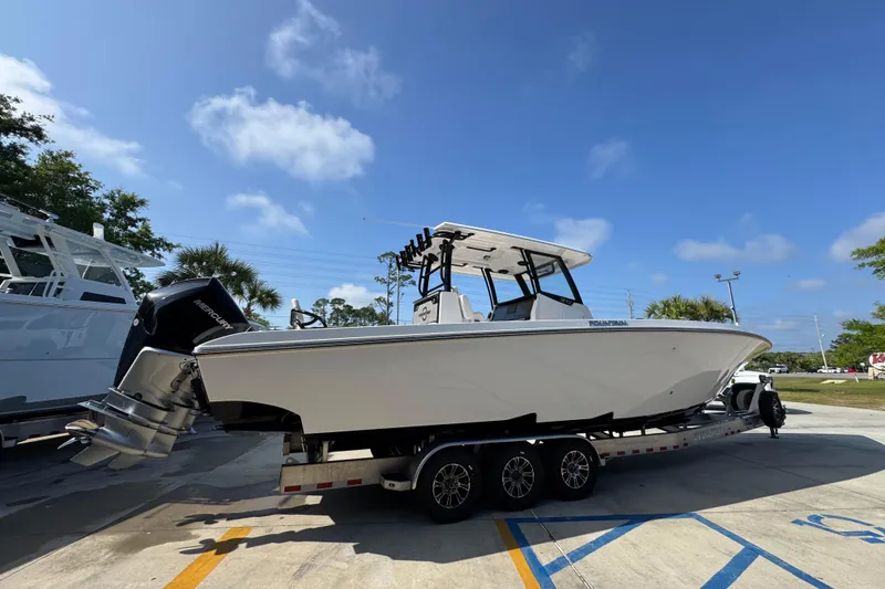 Slide: The Image of 2024 Fountain Bluewater 38 Tournament Edition boat on trailer under clear blue sky. - 9