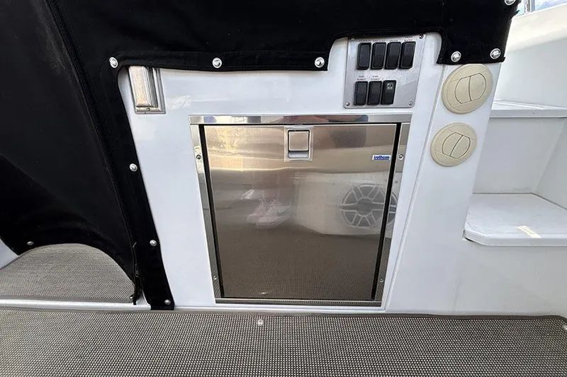 Slide: The Image of 2016 Cruisers Yachts 390 Express Coupe interior with stainless steel panel and control switches. - 10