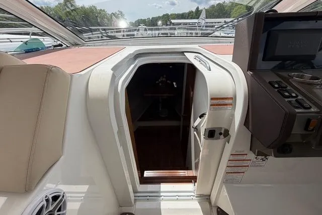 Slide: The Image of 2016 Cruisers Yachts 390 Express Coupe cabin entrance with control panel and seating. - 15
